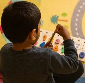 Child at an activity board